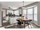 Eat-in kitchen with a ceiling fan, white cabinets, and dark counters adjacent to a dining area at 8415 Anchorage Ct, Indianapolis, IN 46236
