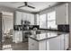 Modern kitchen features white cabinets, stainless appliances, dark backsplash, and island with countertop at 8415 Anchorage Ct, Indianapolis, IN 46236