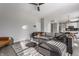 Open living area with a sectional sofa, glass-topped table, and a view of the kitchen at 8415 Anchorage Ct, Indianapolis, IN 46236