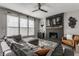 Bright living room with a fireplace, sectional, and large windows offering ample natural light at 8415 Anchorage Ct, Indianapolis, IN 46236