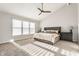 Spacious main bedroom features a vaulted ceiling, ceiling fan, and large windows at 8415 Anchorage Ct, Indianapolis, IN 46236