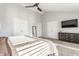 Vaulted ceiling main bedroom with a ceiling fan, dresser and large windows at 8415 Anchorage Ct, Indianapolis, IN 46236