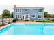 Backyard pool and deck area adjacent to a blue two-story house and fence at 8415 Anchorage Ct, Indianapolis, IN 46236