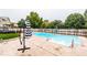 In-ground pool with diving board and deck with lounge furniture and umbrella at 8415 Anchorage Ct, Indianapolis, IN 46236