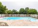 In-ground pool surrounded by a wooden fence, with lush trees and concrete deck at 8415 Anchorage Ct, Indianapolis, IN 46236