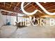 Unfinished basement featuring an open concept, exposed ceiling, and concrete floor at 8500 N Ravenwood Dr, Muncie, IN 47303