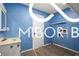 Bathroom featuring a blue textured wall, modern vanity, and bright lighting at 8500 N Ravenwood Dr, Muncie, IN 47303