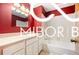 Bathroom featuring a red accent wall, modern vanity, and bathtub with clean, white fixtures at 8500 N Ravenwood Dr, Muncie, IN 47303