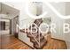 Welcoming entryway showcasing a staircase, hardwood floors, and ample natural light, creating a warm atmosphere at 8500 N Ravenwood Dr, Muncie, IN 47303
