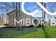Charming home with a stone facade, mature trees, and lush green lawn offering great curb appeal at 8500 N Ravenwood Dr, Muncie, IN 47303