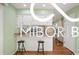 Well-lit kitchen featuring white cabinets, countertops, and a practical island with bar stool seating at 8500 N Ravenwood Dr, Muncie, IN 47303
