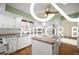 Bright kitchen with white cabinets, butcher block countertops, and a functional center island at 8500 N Ravenwood Dr, Muncie, IN 47303