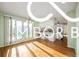 Open concept kitchen and dining area with hardwood floors and large windows for natural light at 8500 N Ravenwood Dr, Muncie, IN 47303