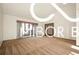 Bright and airy living room with beautiful hardwood floors and large windows allowing for plenty of natural light at 8500 N Ravenwood Dr, Muncie, IN 47303