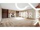 Expansive living area showcases hardwood floors, a neutral color scheme, and a cozy stone fireplace at 8500 N Ravenwood Dr, Muncie, IN 47303