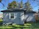 Rear view of the house with a window, green grass, and blue siding at 867 W 25Th St, Indianapolis, IN 46208