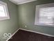Empty bedroom featuring natural light from two windows and carpeted floors at 867 W 25Th St, Indianapolis, IN 46208