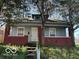 Charming single-story home with a covered porch and mature trees at 867 W 25Th St, Indianapolis, IN 46208