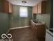 Kitchen with cabinets, a double sink, and window at 867 W 25Th St, Indianapolis, IN 46208