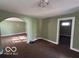 Living room features an open archway, a light fixture, and carpeted floors at 867 W 25Th St, Indianapolis, IN 46208