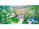 Aerial shot of a property showcasing lush landscaping, a brick facade, and a serene, wooded backdrop at 8695 Shoe Overlook Dr, Fishers, IN 46038