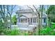 Back view of the house displaying gray siding, screened porch, walkout deck, and wooded surroundings at 8695 Shoe Overlook Dr, Fishers, IN 46038