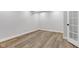 Cozy basement area with wood-look floors, white trim, and a charming paneled door at 8695 Shoe Overlook Dr, Fishers, IN 46038