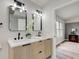 Updated double vanity in bathroom offers sleek lines and natural light from the window at 8695 Shoe Overlook Dr, Fishers, IN 46038