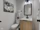 Stylish half-bathroom featuring modern vanity, decorative art, and neutral decor at 8695 Shoe Overlook Dr, Fishers, IN 46038