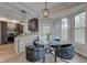 Open-concept eat-in kitchen nook with a round table, chairs, lots of natural light, and modern light fixture at 8695 Shoe Overlook Dr, Fishers, IN 46038