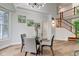 Chic dining area with a glass-top table and stylish chairs, bathed in natural light at 8695 Shoe Overlook Dr, Fishers, IN 46038