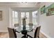 Inviting dining room featuring a glass table set in front of a bright bay window at 8695 Shoe Overlook Dr, Fishers, IN 46038