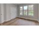 Versatile empty room with wood floors, a large window, and a spacious closet at 8695 Shoe Overlook Dr, Fishers, IN 46038
