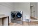 Bright laundry room featuring a washer and dryer set, utility sink, and wood-look floors at 8695 Shoe Overlook Dr, Fishers, IN 46038