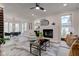 Spacious living room with breakfast nook, fireplace, modern decor, and abundant natural light at 8695 Shoe Overlook Dr, Fishers, IN 46038