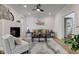 Bright living room with a cozy fireplace, modern furnishings, ceiling fan and neutral color palette at 8695 Shoe Overlook Dr, Fishers, IN 46038