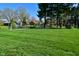 A well-maintained backyard with lush green grass, a soccer goal, and mature trees at 8808 Rocky Hill Rd, Indianapolis, IN 46217