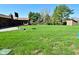 Expansive backyard with a basketball hoop, storage shed, and a home playground, perfect for outdoor activities at 8808 Rocky Hill Rd, Indianapolis, IN 46217