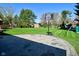 Spacious backyard with lush green grass, a basketball hoop, storage shed, and an outdoor play area at 8808 Rocky Hill Rd, Indianapolis, IN 46217