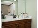 Bathroom vanity with a white countertop, dark wood cabinets and a white framed mirror at 8808 Rocky Hill Rd, Indianapolis, IN 46217