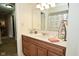 Bright bathroom featuring a single sink vanity with wood cabinets and a decorative mirror at 8808 Rocky Hill Rd, Indianapolis, IN 46217