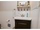 Bathroom featuring white sink, dark wood cabinet, and decorative accents at 8808 Rocky Hill Rd, Indianapolis, IN 46217