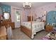 Charming bedroom featuring a four-post bed, patterned wallpaper, and a ceiling fan with light fixture at 8808 Rocky Hill Rd, Indianapolis, IN 46217