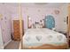 Bright bedroom featuring a four-post bed, patterned wallpaper, and natural light at 8808 Rocky Hill Rd, Indianapolis, IN 46217