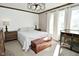 Cozy bedroom with natural light, a wood accent wall, and a decorative chest at 8808 Rocky Hill Rd, Indianapolis, IN 46217