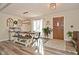 Bright dining room with wood-look flooring, farmhouse-style table, and a door that goes outside at 8808 Rocky Hill Rd, Indianapolis, IN 46217