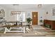 Sun-filled dining area with wood-look floors and views of the front yard from the window at 8808 Rocky Hill Rd, Indianapolis, IN 46217