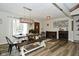 Open-concept dining room with wood-look floors, a modern chandelier, and views of the front yard at 8808 Rocky Hill Rd, Indianapolis, IN 46217