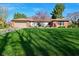 Well-maintained ranch home featuring a green lawn, brick facade, and attached two car garage at 8808 Rocky Hill Rd, Indianapolis, IN 46217