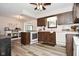 Functional kitchen with white appliances, wood cabinets, and wood-look floors at 8808 Rocky Hill Rd, Indianapolis, IN 46217